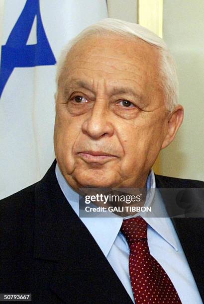 Israeli Prime Minister Ariel Sharon looks on during a meeting with California Governor Arnold Schwarzenegger at his Jerusalem office 02 May 2004....