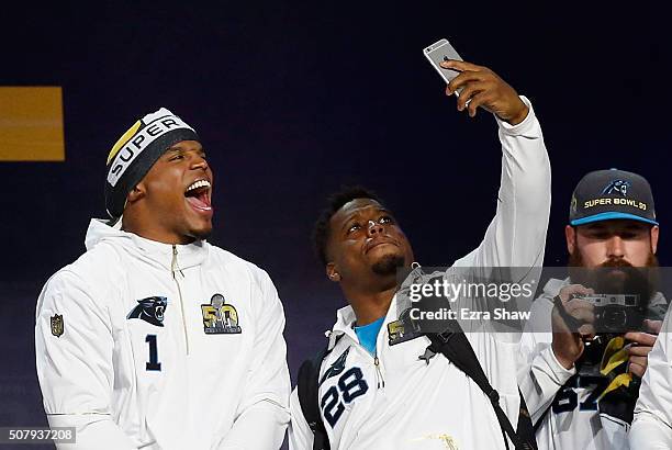 Cam Newton of the Carolina Panthers and Jonathan Stewart take a picture together as they are introduced at Super Bowl Opening Night Fueled by...