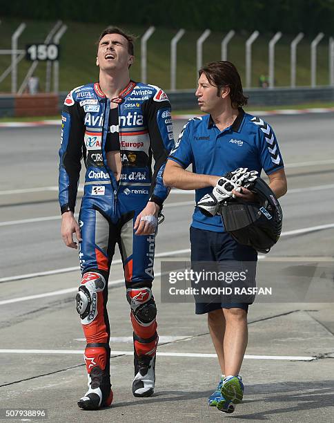 Avintia Racing Ducati rider Loris Baz of France reacts after his rear bike tyre exploded on the main straight line during the second day of 2016...