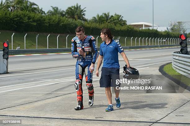 Avintia Racing Ducati rider Loris Baz of France reacts after his rear bike tyre exploded on the main straight line during the second day of 2016...