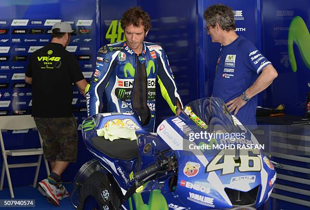 Movistar Yamaha MotoGP rider Valentino Rossi of Italy looks at his bike before the second day of 2016 MotoGP pre-season test at the Sepang...