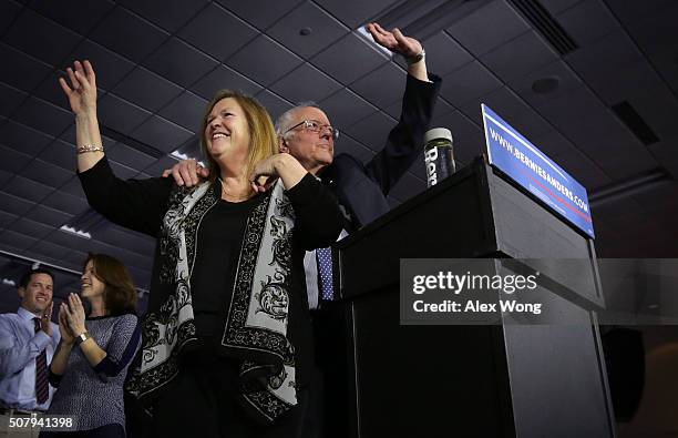 Democratic presidential candidate Sen. Bernie Sanders and his wife Jane O'Meara Sanders wave on stage during a caucus night party February 1, 2016 in...