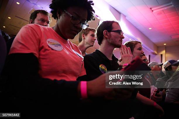 Supporters wait for results during Democratic presidential candidate Sen. Bernie Sanders' caucus night party February 1, 2016 in Des Moines, Iowa....