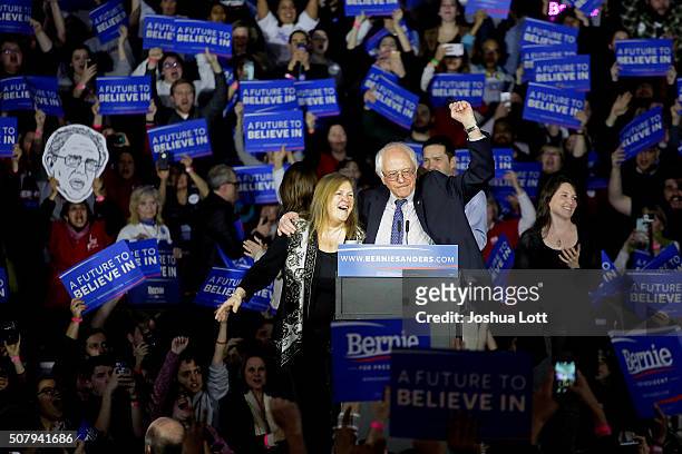 Democratic presidential candidate Bernie Sanders stands on stage with his wife Jane O'Meara Sanders during his Caucus night event at the at the...