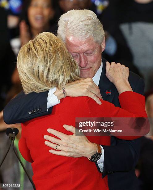 Democratic presidential candidate former Secretary of State Hillary Clinton and Former U.S. President Bill Clinton hug during her caucus night event...