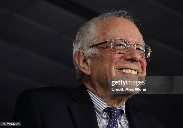 Democratic presidential candidate Sen. Bernie Sanders smiles as he speaks to supporters during a caucus night party February 1, 2016 in Des Moines,...