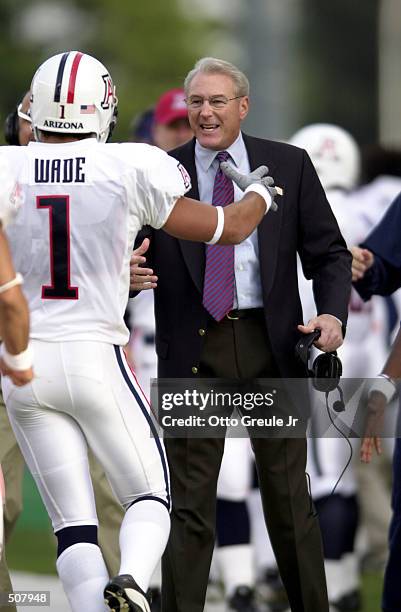 Head coach John Mackovic of Arizona greets Bobby Wade during the game against Washington at Husky Stadium in Seattle, Washington. The Washington...