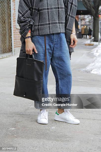 Jon Carlo seen at Industria Superstudios wearing white and green Adidas sneakers, Chimala jeans, grey Sonsea top with shawl and black leather Want...