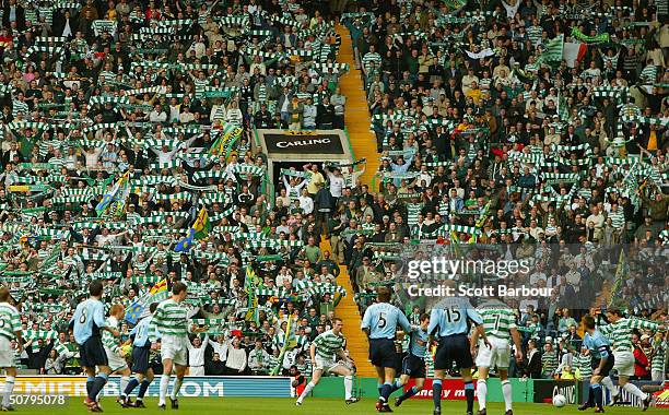 Celtic fans cheer during the Scottish Premier League match between Glasgow Celtic and Dunfermline Athletic played at Celtic Park on May 2, 2004 in...