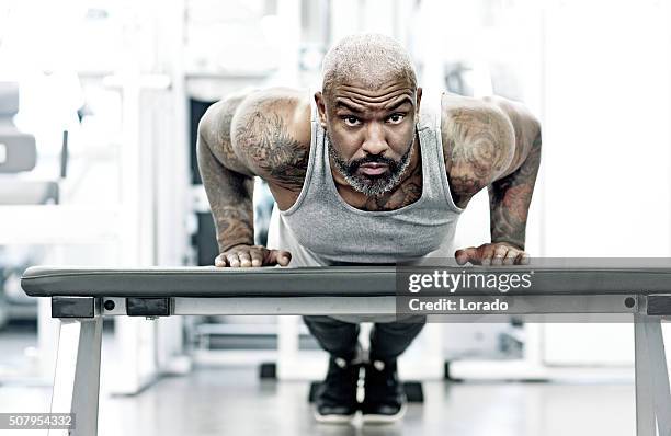 athletic black man exercising indoors - black male bodybuilders stock pictures, royalty-free photos & images