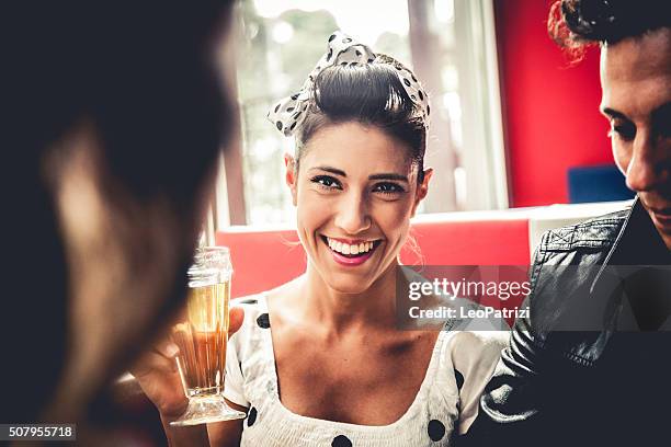 friends enjoying together lunch in a cafe - rockabilly stock pictures, royalty-free photos & images