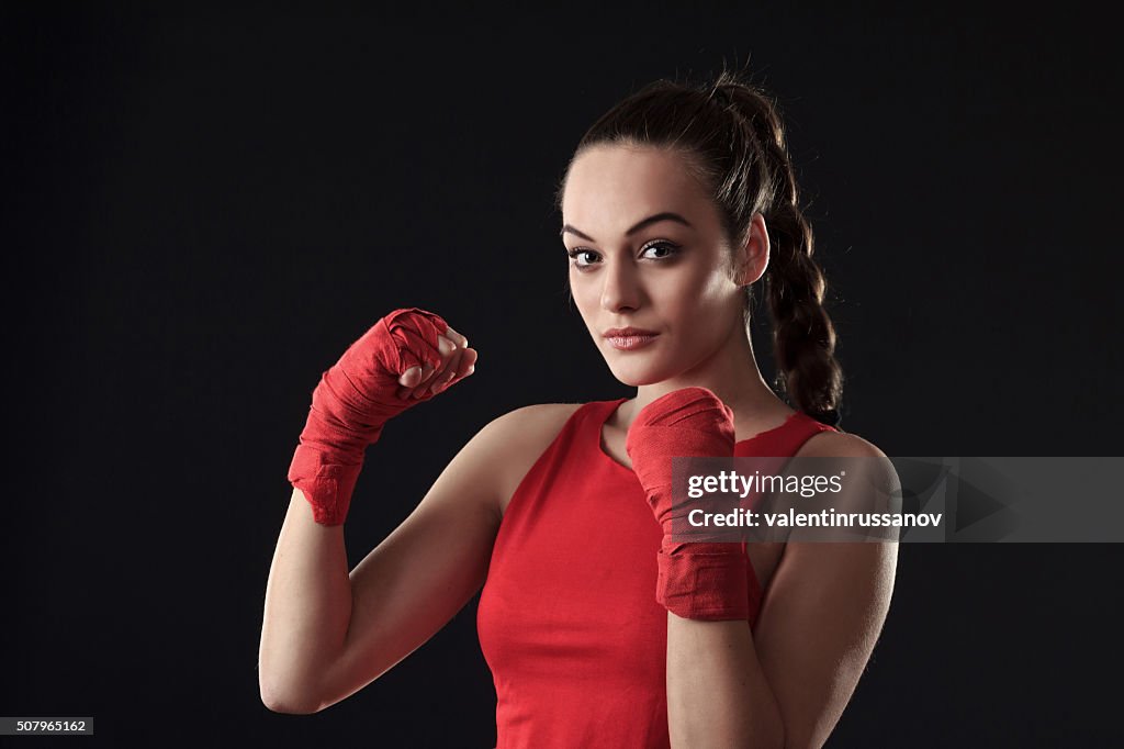 Mujer joven posando en boxeo -trenza ajuste de cabello