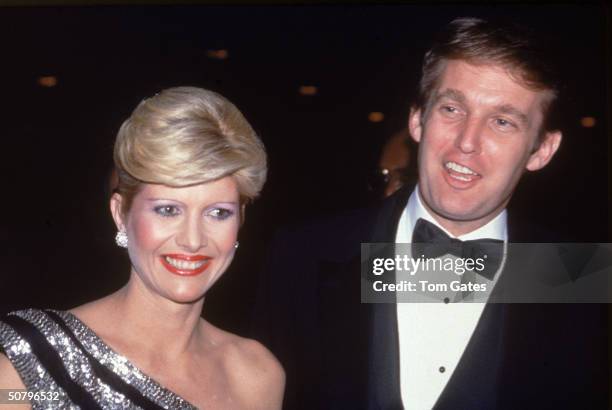 American businessman Donald Trump and his wife Ivana smile as they attend a formal party, 1982.