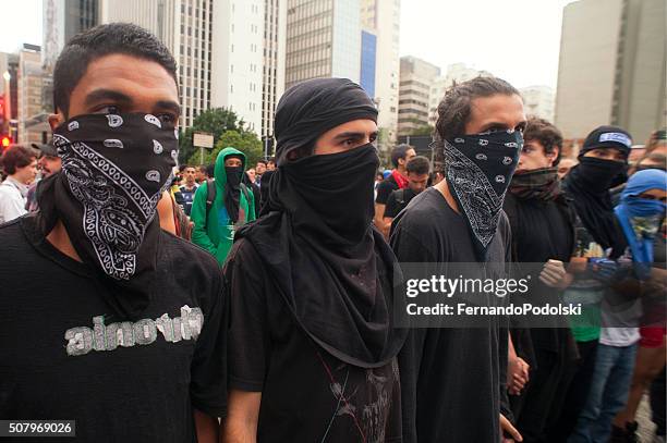 demonstrators - masked protesters stock pictures, royalty-free photos & images