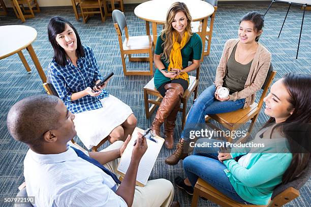 young adult creative professionals discuss project in group - teacher meeting stock pictures, royalty-free photos & images