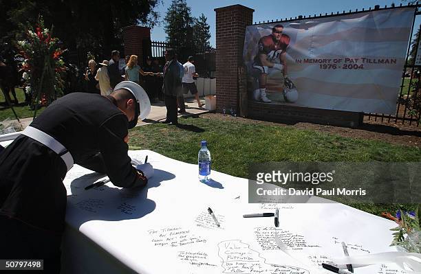 Soldier signs a memorial during a service held by the family of Cpl. Pat Tillman for Tillman, who was killed in action in Afghanistan April 22 at the...