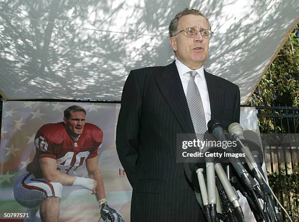 Commissioner Paul Tagliabue speaks in front of a poster of Arizona Cardinals Pat Tillman during a news conference before the memorial service for...
