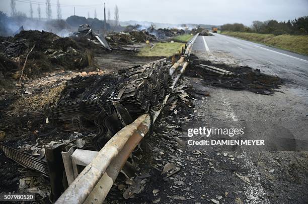 Photo taken on February 2, 2016 shows the cleaning of the RN165 highway near Arzal, western France, after a week of demonstrations and road blockades...