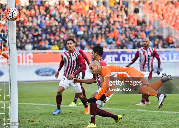 Diego Tardelli of Shandong Luneng jumps to head the ball during the 2016 AFC Champions League qualifying match between Shandong Luneng and Mohun...