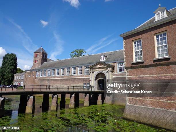 Close up view with entrance and canal of the complex of the Royal Military Academy of the Netherlands in Breda, Historic building, sunny summer day,...