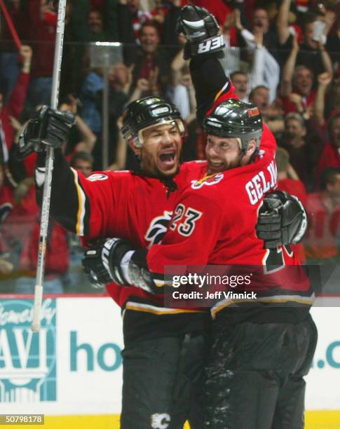 Martin Gelinas of the Calgary Flames celebrates his overtime winning goal with teammate Jarome Iginla during the first overtime period of game six of...