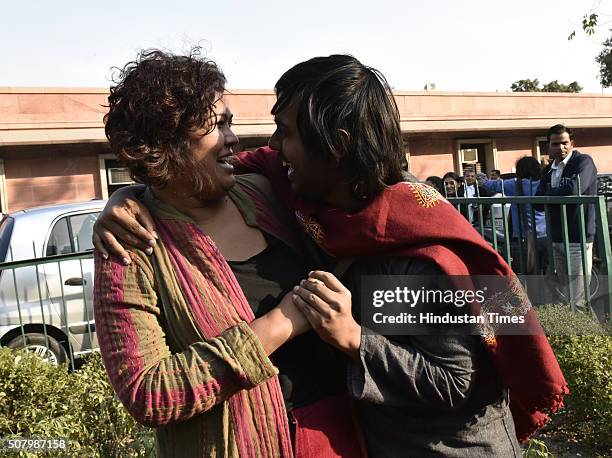 Indian gay rights activists hug each other outside the Supreme Court as it agreed to refer a curative petition challenging Section 377 of the Indian...