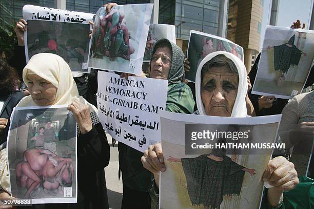 Lebanese women hold up 04 May 2004 copies of the released photos showing US troops humiliating Iraqi prisoners in Abu Gharib jail, a former dreaded...