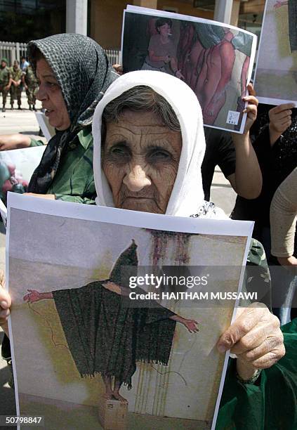 Lebanese women hold up 04 May 2004 copies of the released photos showing US troops humiliating Iraqi prisoners in Abu Gharib jail, a former dreaded...