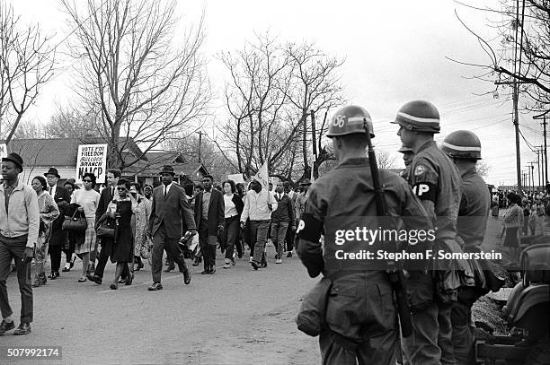 Federal Army troops guard civil rights marchers striding along route 80, the Jefferson Davis Highway during the Selma to Montgomery Civil Rights...