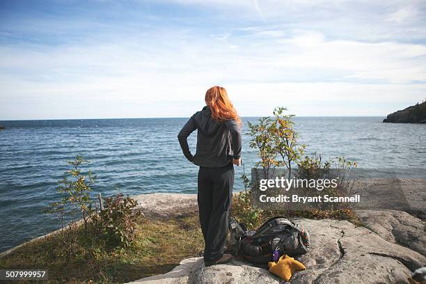 woman looking at lake superior - duluth minnesota stock pictures, royalty-free photos & images