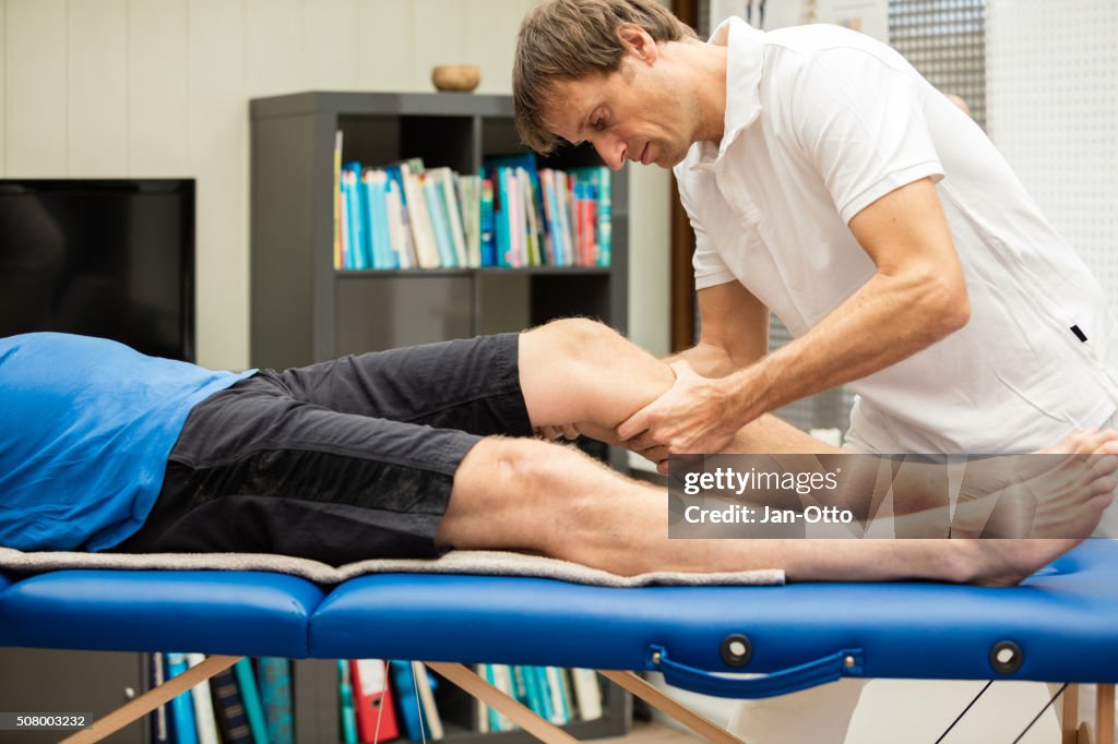 Doctor testing the knee with the Lachman Test