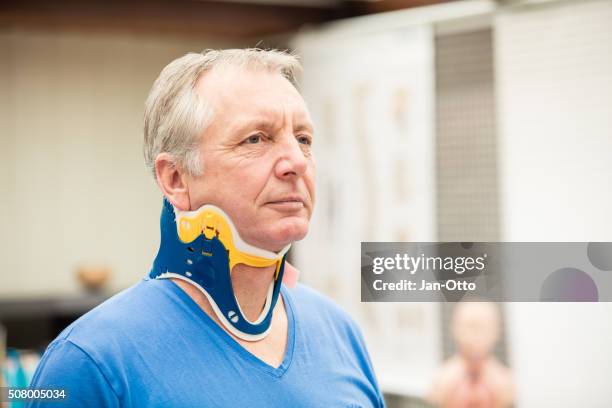 mature patient wearing a spine collar - menselijke nek stockfoto's en -beelden