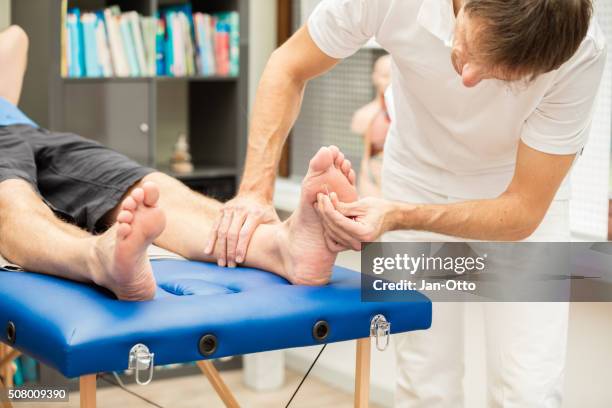 doctor testing sensibility of foot - människofot bildbanksfoton och bilder