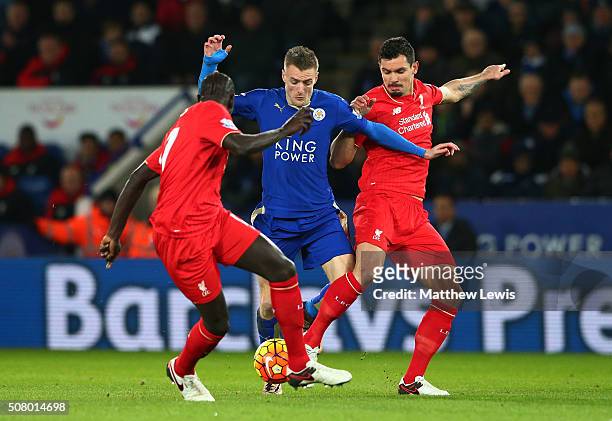 Jamie Vardy of Leicester City controls the ball against Dejan Lovren and Mamadou Sakho of Liverpool during the Barclays Premier League match between...