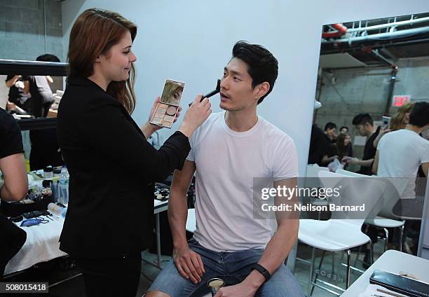 Model prepares backstage at the Nautica Men's Fall 2016 fashion show during New York Fashion Week Men's Fall/Winter 2016 at Skylight Modern on...