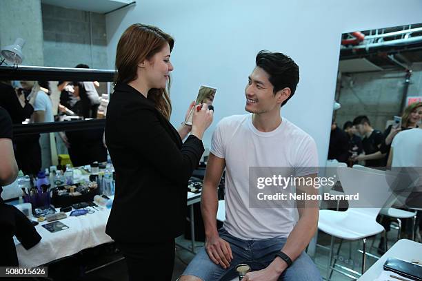 Model prepares backstage at the Nautica Men's Fall 2016 fashion show during New York Fashion Week Men's Fall/Winter 2016 at Skylight Modern on...