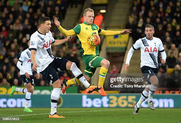 Steven Naismith of Norwich City and Kevin Wimmer of Tottenham Hotspur compete for the ball during the Barclays Premier League match between Norwich...