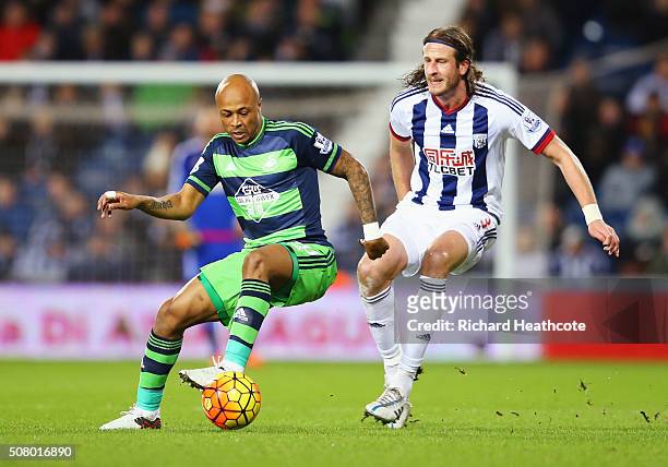 Andre Ayew of Swansea City and Jonas Olsson of West Bromwich Albion compete for the ball during the Barclays Premier League match between West...