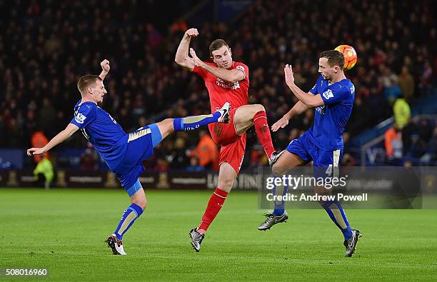 Jordan Henderson of Liverpool competes with Marc Albrighton and Daniel Drinkwater of Leicester City during the Barclays Premier League match between...