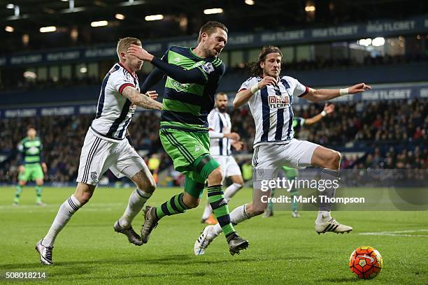 Gylfi Sigurdsson of Swansea City competes for the ball against James McClean and Jonas Olsson of West Bromwich Albion during the Barclays Premier...