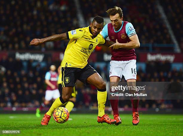 Leandro Bacuna of Aston Villa and Mark Noble of West Ham United compete for the ball during the Barclays Premier League match between West Ham United...