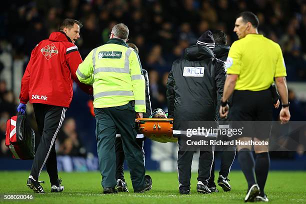 Ki Sung-Yeung of Swansea City is stretched off the pitch after picking up injury during the Barclays Premier League match between West Bromwich...