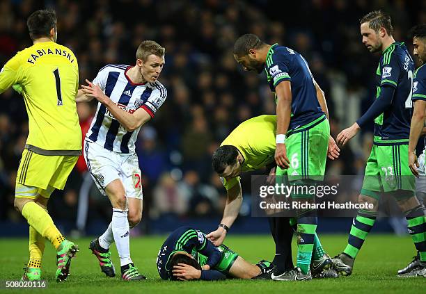 Ki Sung-Yeung of Swansea City lies injured during the Barclays Premier League match between West Bromwich Albion and Swansea City at The Hawthorns on...