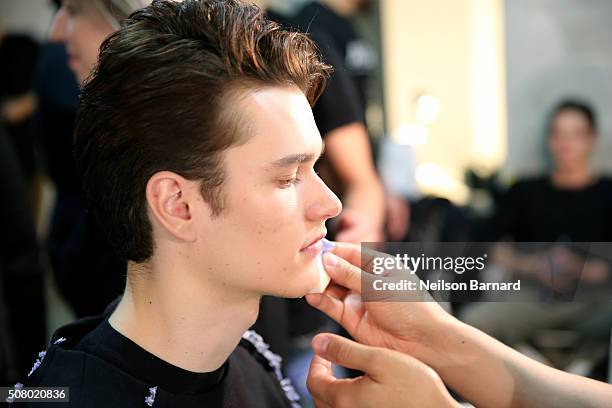 Model prepares backstage at the Nautica Men's Fall 2016 fashion show during New York Fashion Week Men's Fall/Winter 2016 at Skylight Modern on...