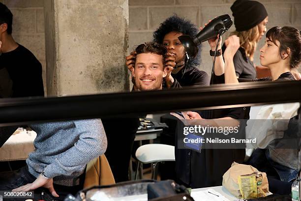 Model prepares backstage at the Nautica Men's Fall 2016 fashion show during New York Fashion Week Men's Fall/Winter 2016 at Skylight Modern on...