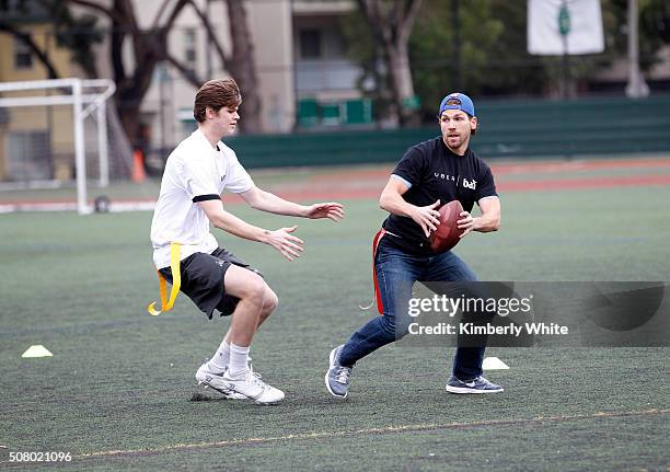 Uber users enjoy a game of flag football during "QB Legends On Demand" presented by Uber and Bai at Raymond Kimbell Playground on February 2, 2016 in...