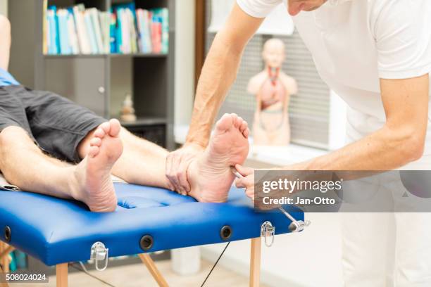 doctor testing babinski reflex - neuropathy stock pictures, royalty-free photos & images