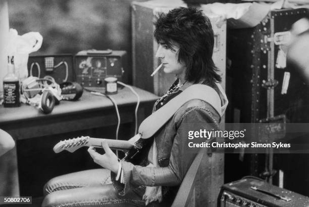 Guitarist Ron Wood tunes up before a concert during the Rolling Stones Tour of the Americas, 1975.