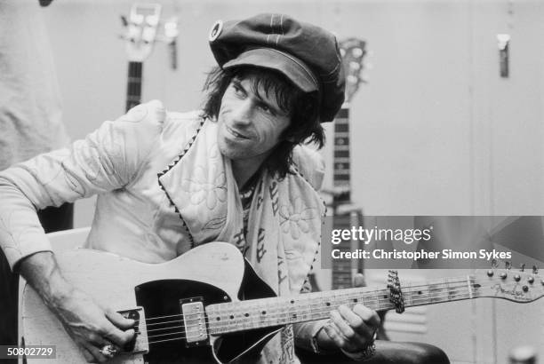 Guitarist Keith Richards strums backstage during the Rolling Stones Tour of the Americas, 1975.