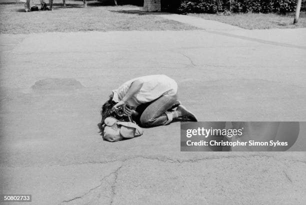 Photographer Annie Liebovitz gets an angle on her subject during the Rolling Stones Tour of the Americas, 1975.